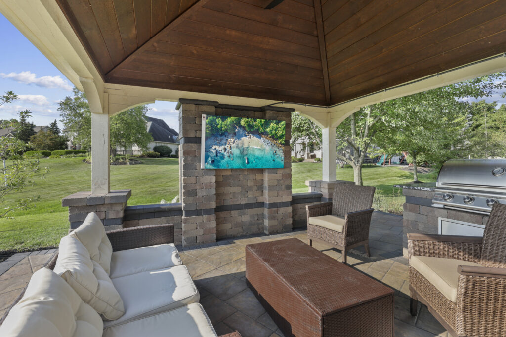 Flores Outdoor Living Space #4 - Flores Landscapes Beautiful outdoor living space with TV, couches, and bricks in Central Ohio