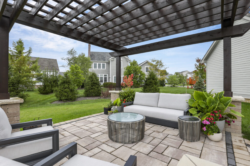 Flores Custom Pergolas #20 - Flores Landscapes Modern black metal pergola with clean lines over tropical plants and outdoor seating in Central Ohio