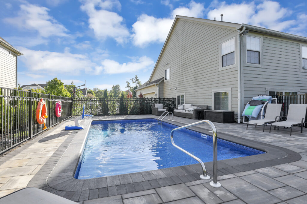 Flores Custom Built Pools #14 - Flores Landscapes Custom paver patio with in-ground pool and outdoor seating in Central Ohio