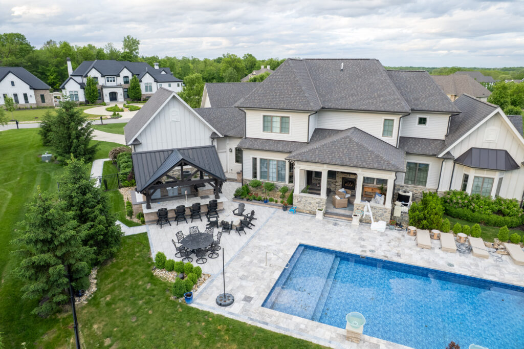 FloresLandscapesMalinowskiOutdoorLivingArea_5-15-25-14 - Flores Landscapes Hardscape project with custom bar, seating, paver patio, and pool in Central Ohio