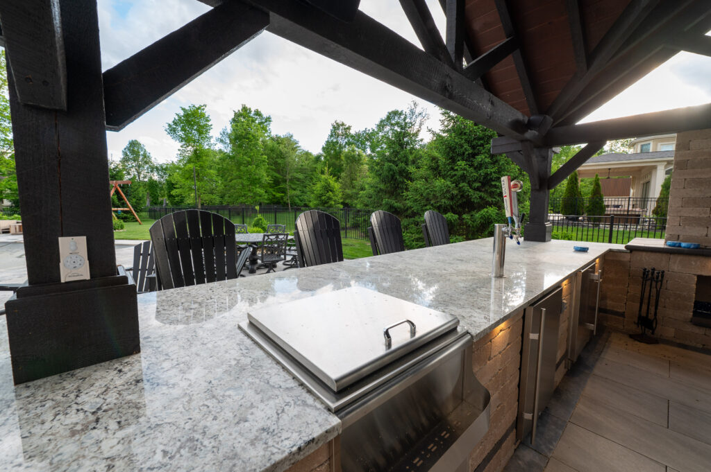 FloresLandscapesMalinowskiOutdoorLivingArea_5-15-25-8 - Flores Landscapes Outdoor kitchen bar with stainless steel appliances in Central Ohio