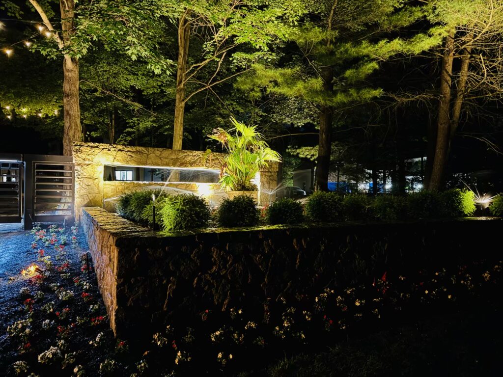 IMG_4911 - Flores Landscapes Tropical landscape bed with bright blooms and layered textures beside a pool